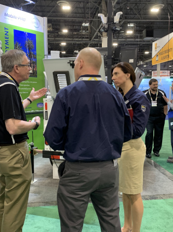 Steve Dunker, left, discusses product options with two conference attendees.