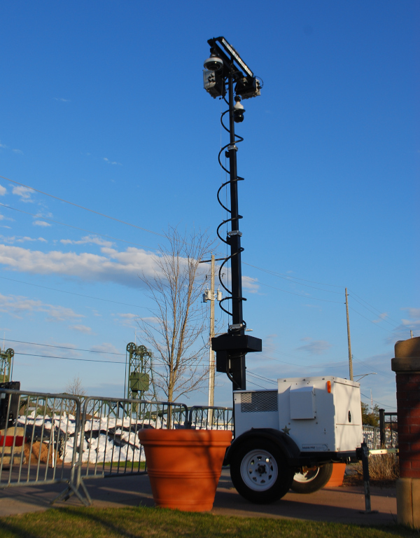 Falcon 3100 mobile security trailer posted by sandbags near flood zone.