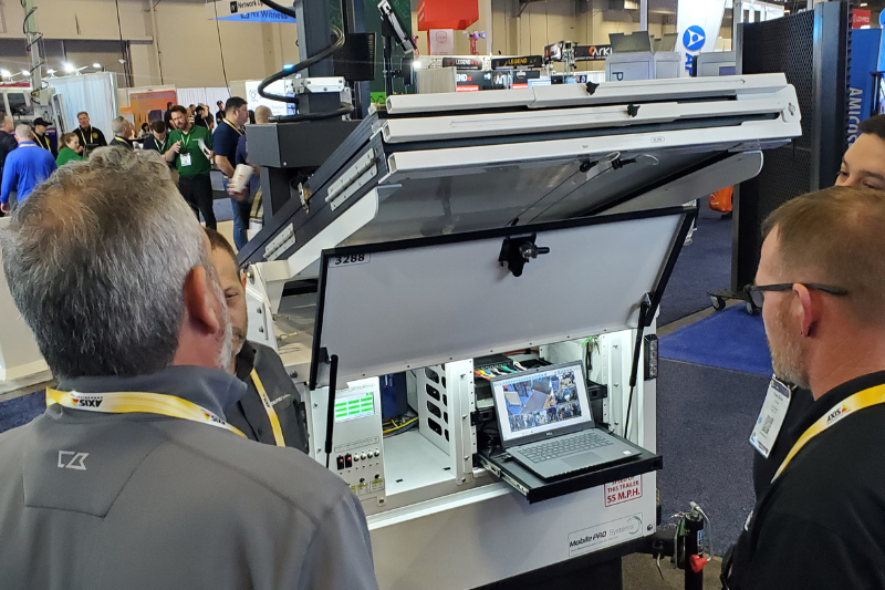 ISC West 2025 visitors watch and listen to Commander 3400 surveillance trailer demo at Mobile Pro Systems booth.