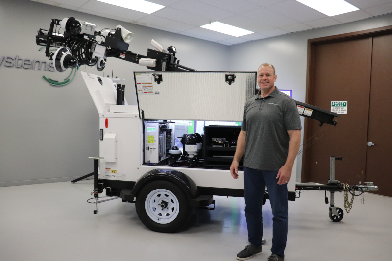 Karl Olson, Solutions Consultant with Mobile Pro Systems, pictured beside Commander 3400 mobile surveillance trailer.