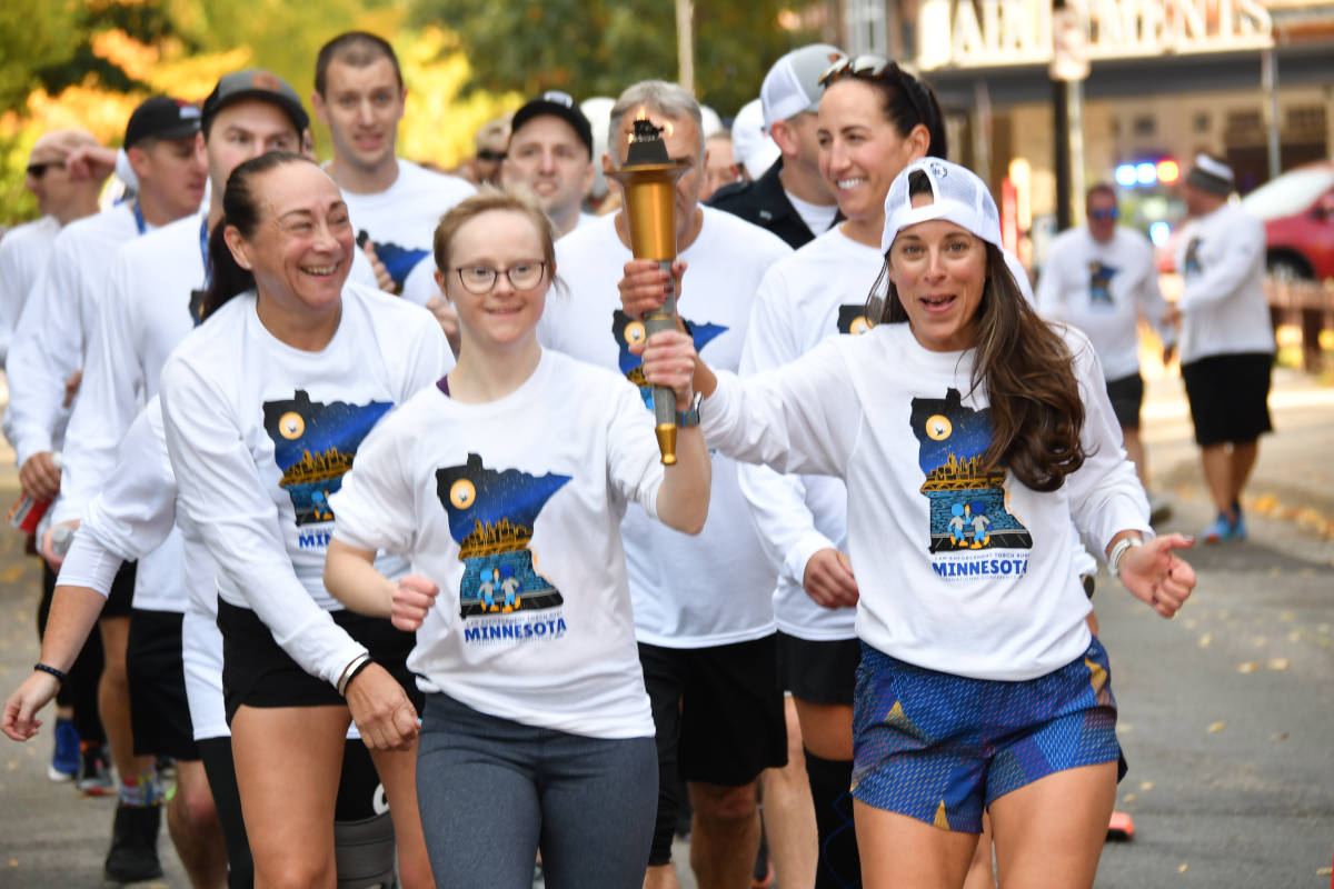 Special Olympian and volunteers carry the Flame of Hope in Minneapolis on October 18, 2025.